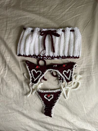 two crocheted bikinis and a bikini laying on a bed