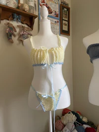 two mannequins with crocheted lingerie in front of them