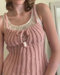 a woman wearing a pink crocheted tank top