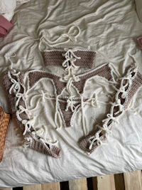 a bed with a crocheted bikini set on it