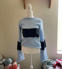 a blue and black sweater on a mannequin mannequin