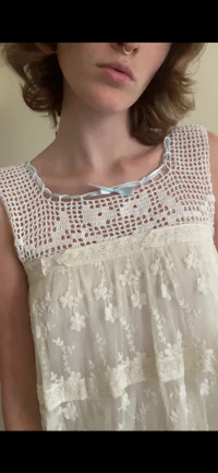 a woman wearing a white lace top