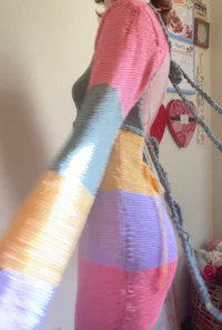 a woman in a colorful dress is standing in a room