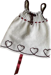 a white crocheted dress with hearts on it