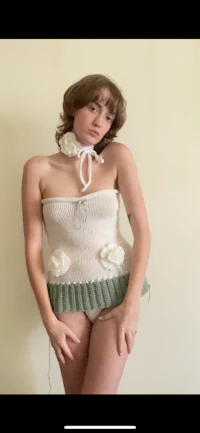 a woman posing in a knitted top
