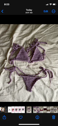 two crocheted bikinis on a bed