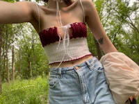 a woman is taking a selfie in the woods