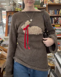 a woman wearing a sweater with a rabbit on it