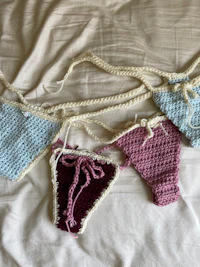 four crocheted bikinis on a bed