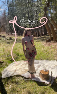 the roses magazine cover with a woman sitting on a blanket in the woods